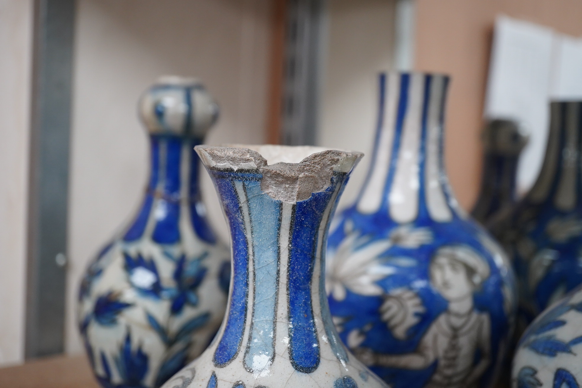 A large collection of Persian, predominantly blue and white, guglets, 18th century, largest 21.5cm. Condition - mostly damaged